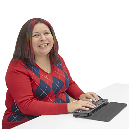 A young blind woman smiles broadly while working on her Braille notetaker.